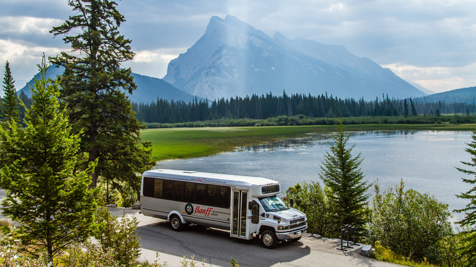 24 Passenger Bus in front of Vermilion Lakes in Banff