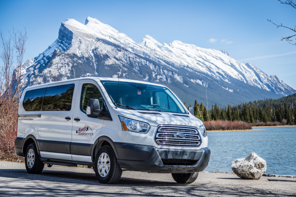 Full Size Tour Vans in front of Mount Rundle in Banff